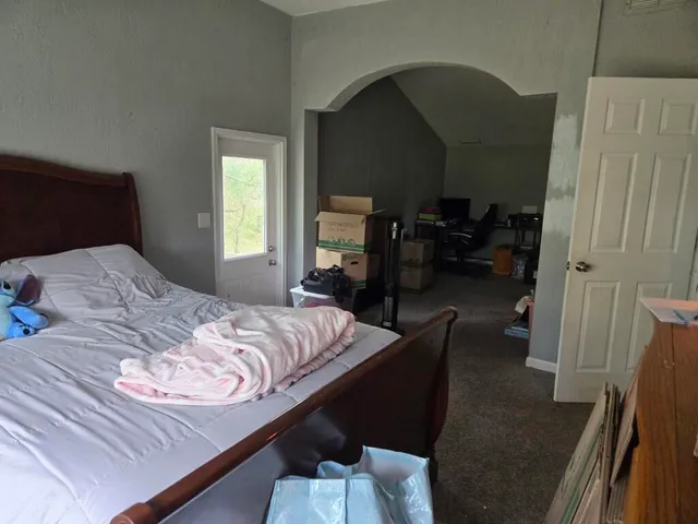 a bedroom with a bed and a mirror