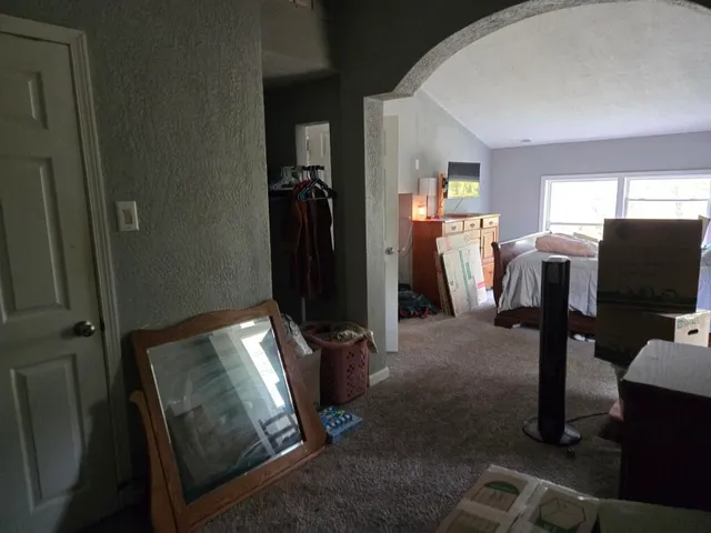 a bedroom with bed and a window