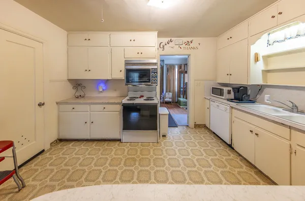 a kitchen with stainless steel appliances granite countertop a sink and cabinets