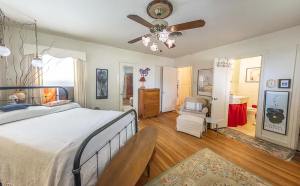 a bedroom with bed and a chandelier