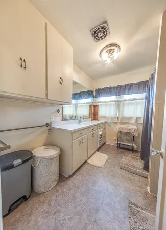 a kitchen with a sink cabinets and window