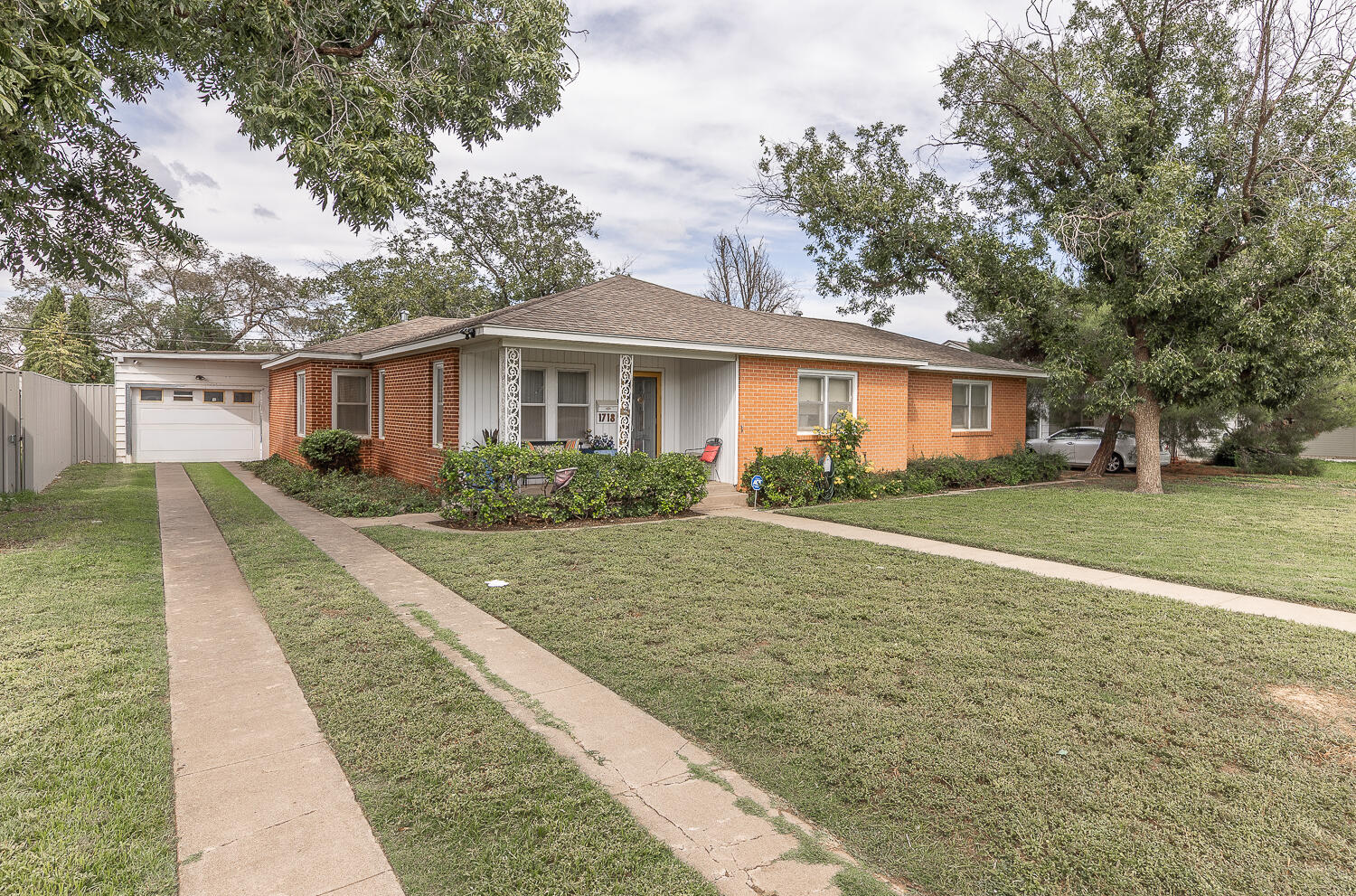 1718 28th Street Lubbock, TX 79411 - Photo 2 of 23 a front view of house with yard and green space