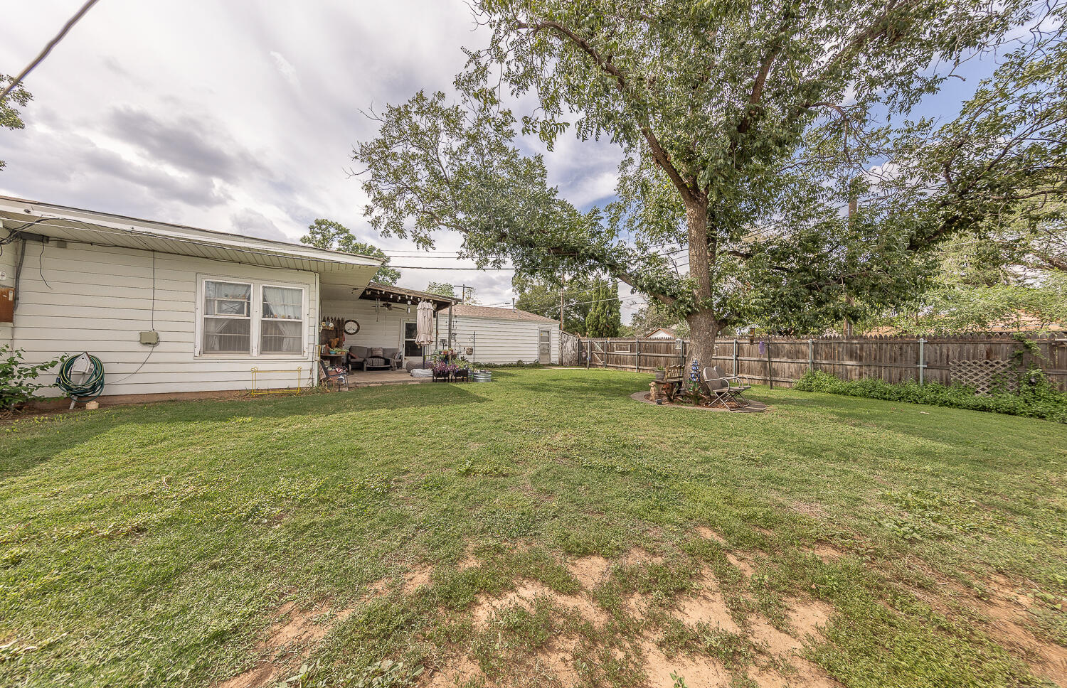 1718 28th Street Lubbock, TX 79411 - Photo 22 of 23 a view of a house with backyard and a tree