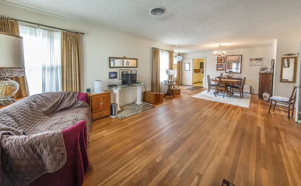 a living room with furniture and wooden floor