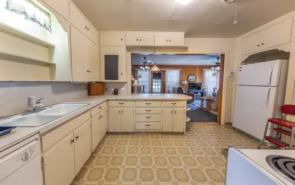 a kitchen with a sink stove and cabinets