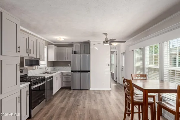 a kitchen with white cabinets and stainless steel appliances