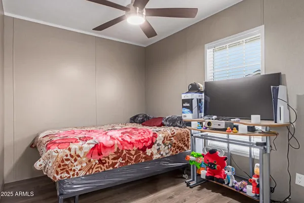 a bedroom with a bed and flat screen tv