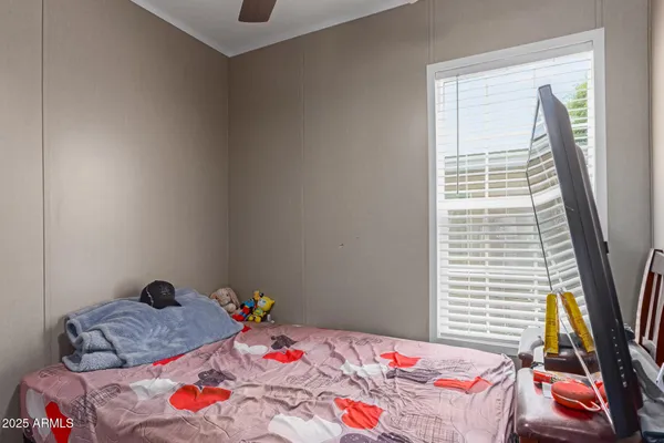 a bedroom with a bed and a window