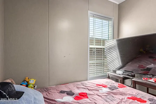 a bedroom with a bed and a window