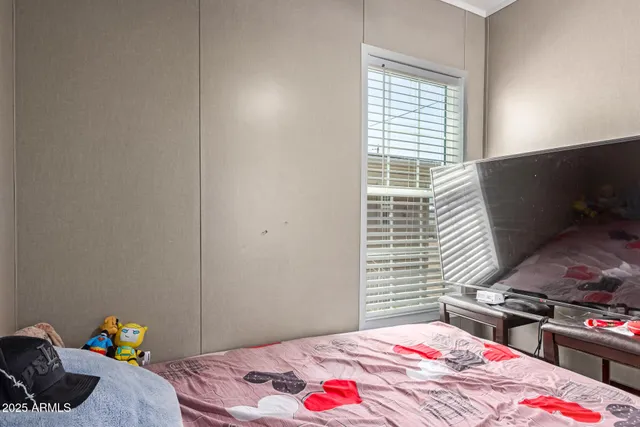 a bedroom with a bed and a window