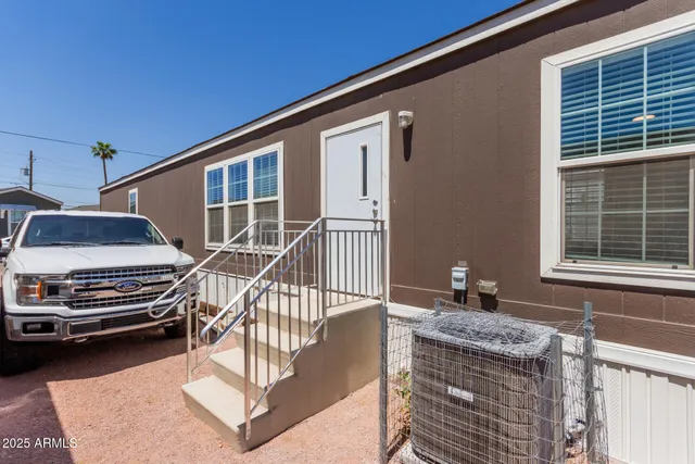 a backyard of a house with barbeque oven and outdoor seating