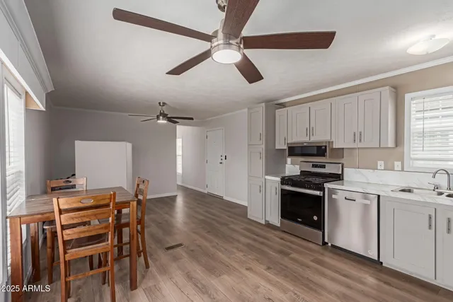 a kitchen with stainless steel appliances a stove a sink and a refrigerator
