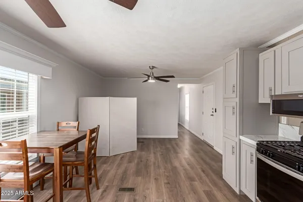 a view of a kitchen with workspace and wooden floor