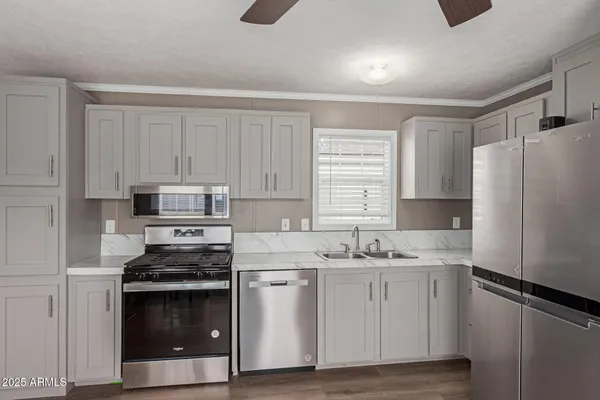 a kitchen with a sink stove and refrigerator