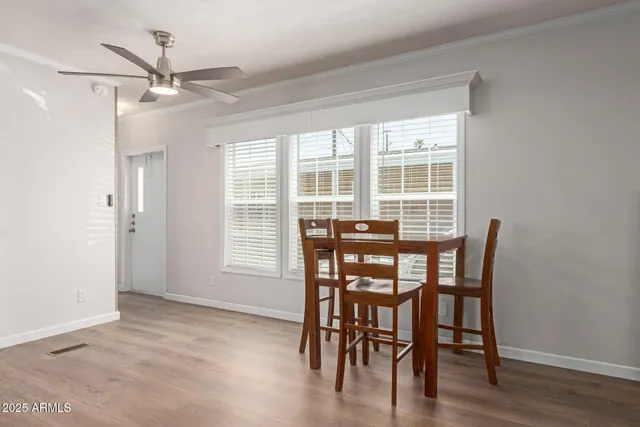 a dining room with furniture window and wooden floor