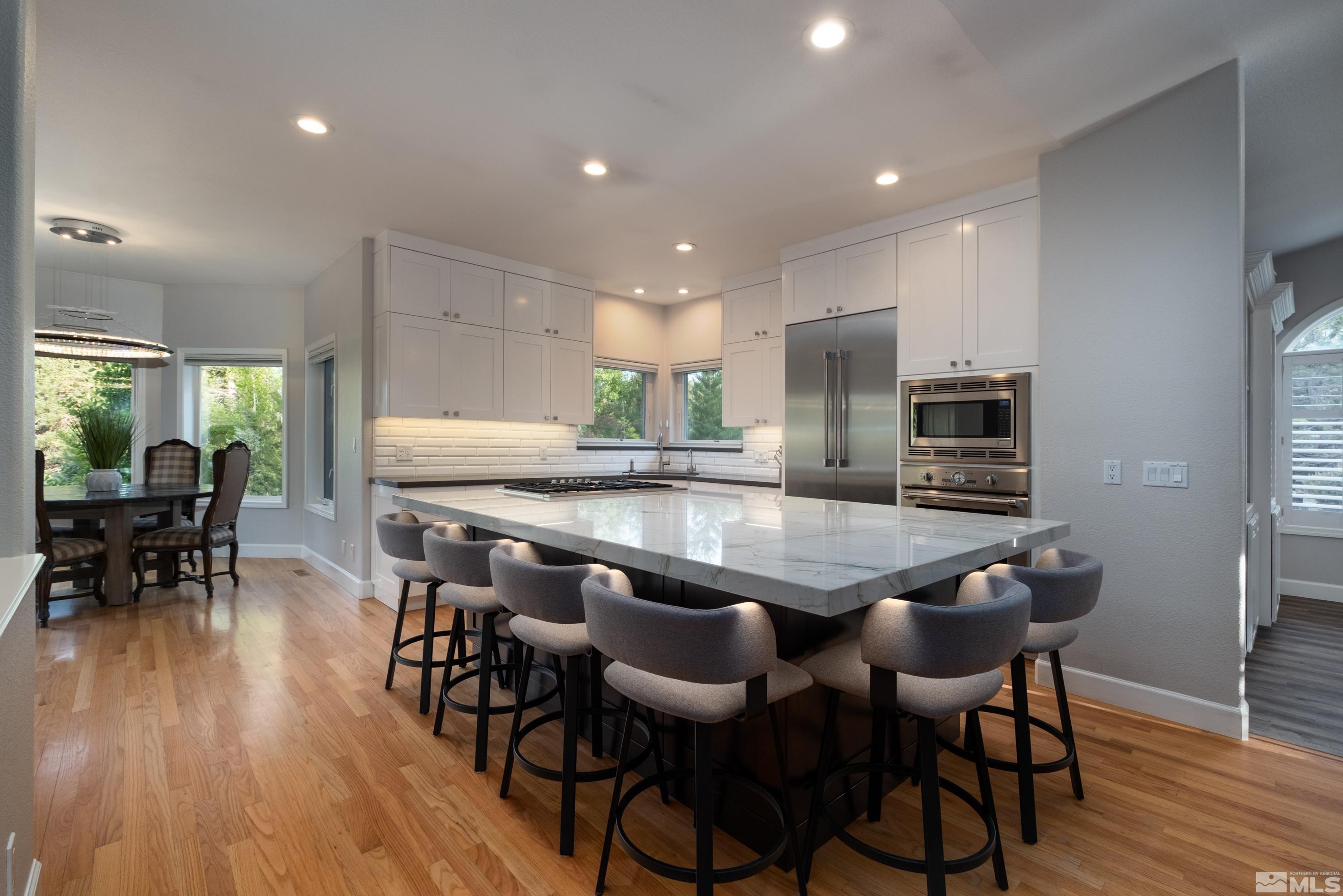 4300 Juniper Trail Reno, NV 89519 - Photo 22 of 39 a dining table with chairs and wooden floor