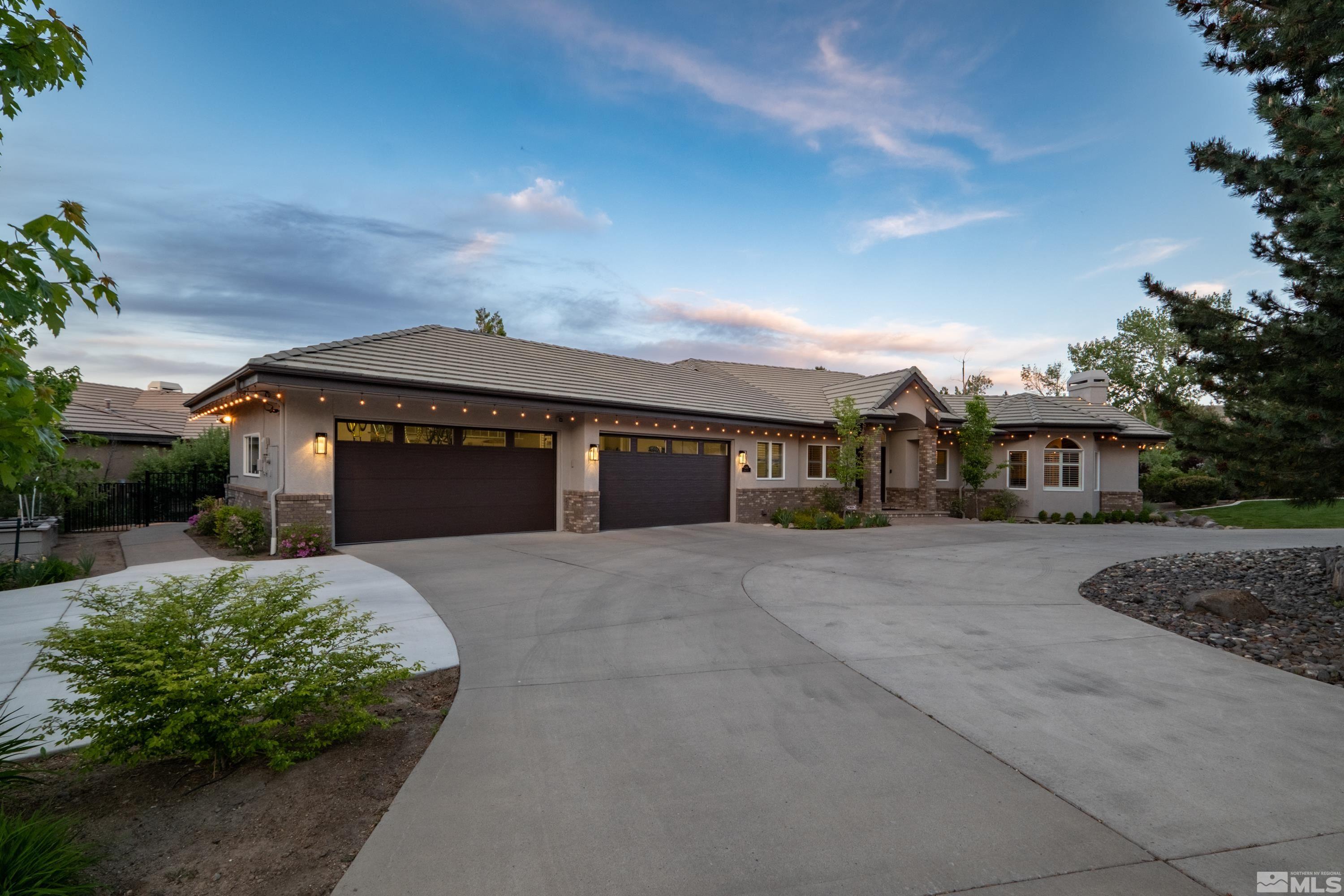 4300 Juniper Trail Reno, NV 89519 - Photo 3 of 39 a front view of a house with a yard and garage