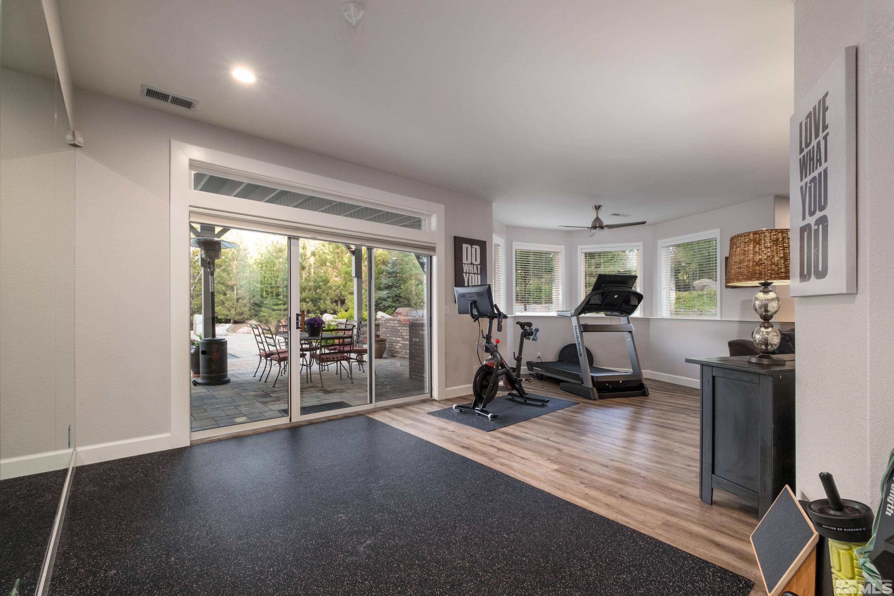 4300 Juniper Trail Reno, NV 89519 - Photo 32 of 39 a living room with furniture a large window and gym equipment