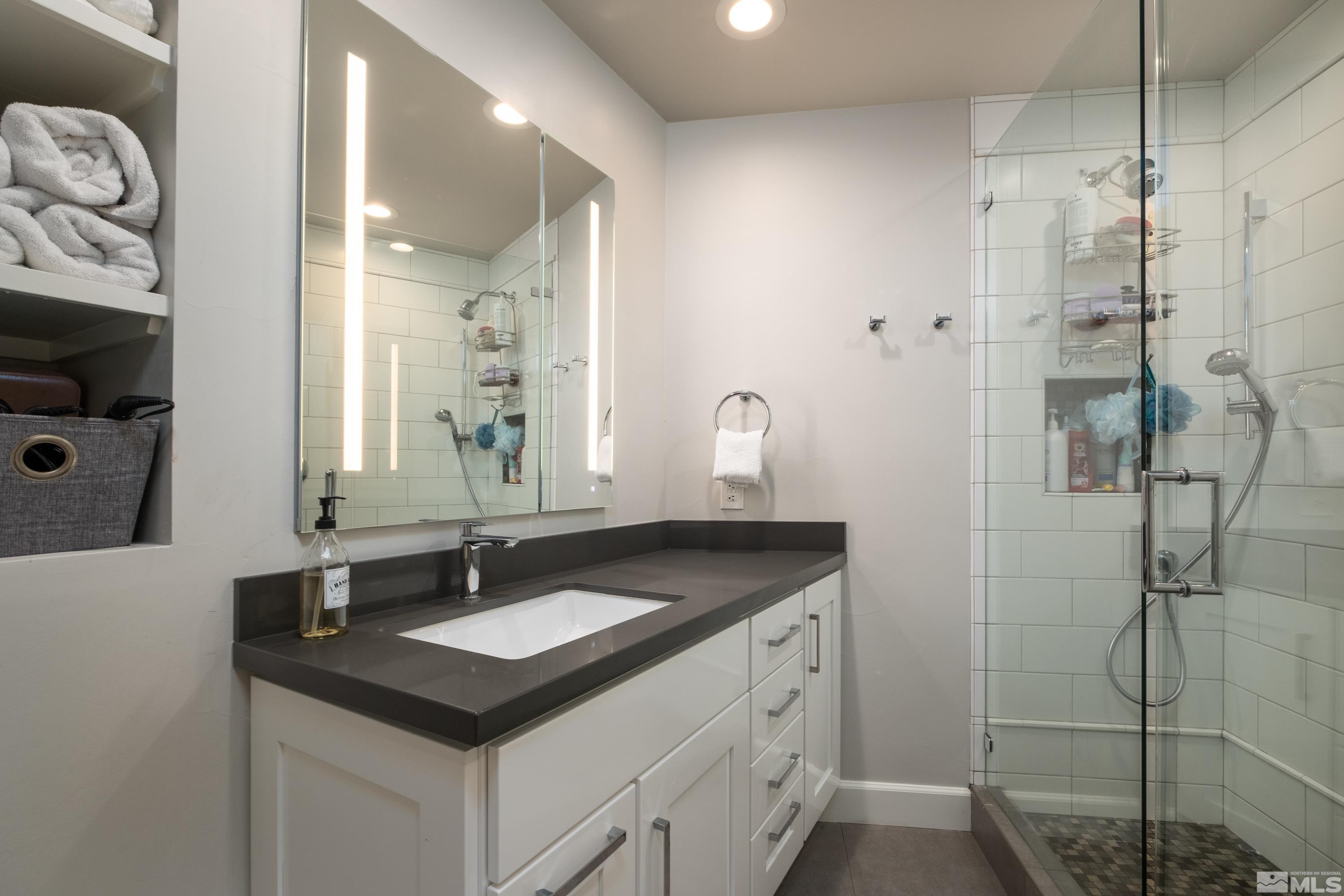 4300 Juniper Trail Reno, NV 89519 - Photo 38 of 39 a bathroom with a sink and a mirror