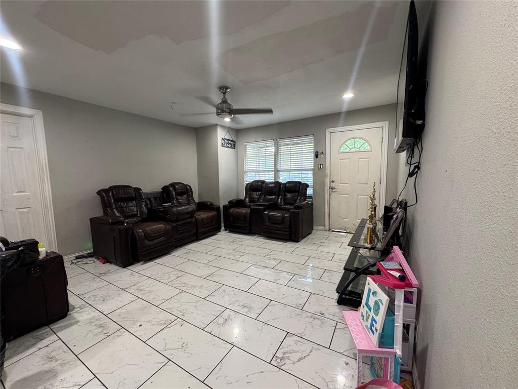 1104 Ridgeview Street Mesquite, TX 75149 - Photo 2 of 6 Living area with light marble finish flooring and ceiling fan
