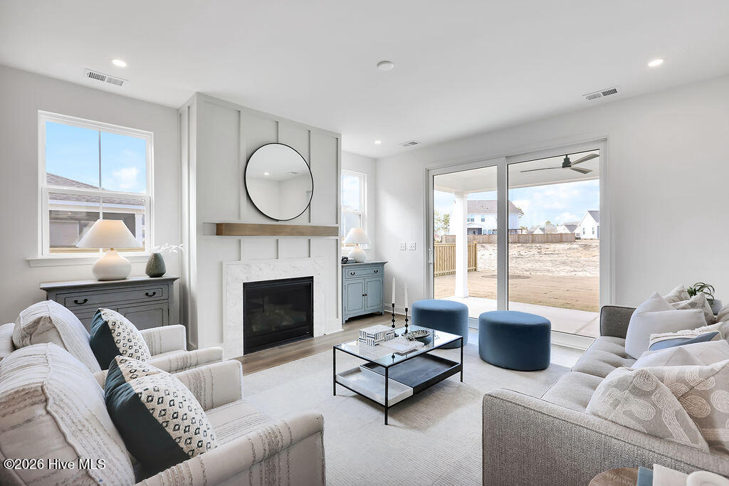 745 Caisson Run Wilmington, NC 28412 - Photo 2 of 43 Living Room with a natural gas fireplace and an abundance of natural light