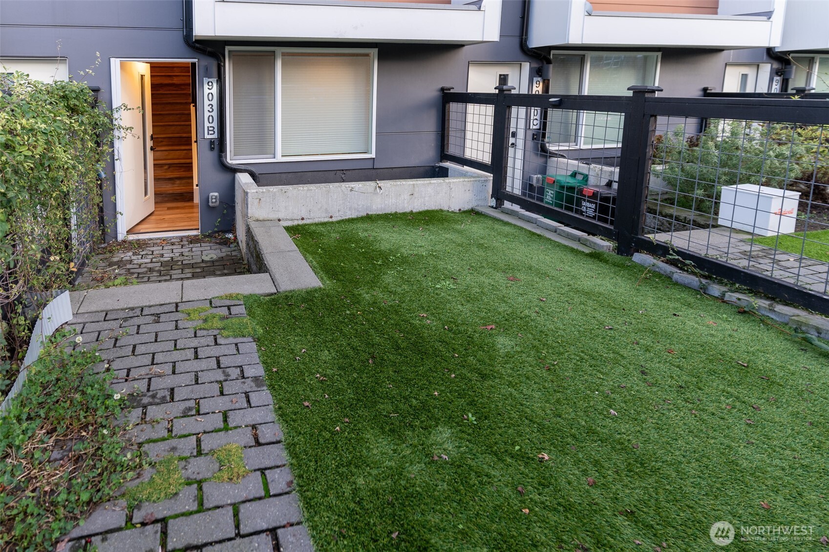 9030 18th Avenue Southwest, Unit B Seattle, WA 98106 - Photo 2 of 20 a front view of a house with a yard