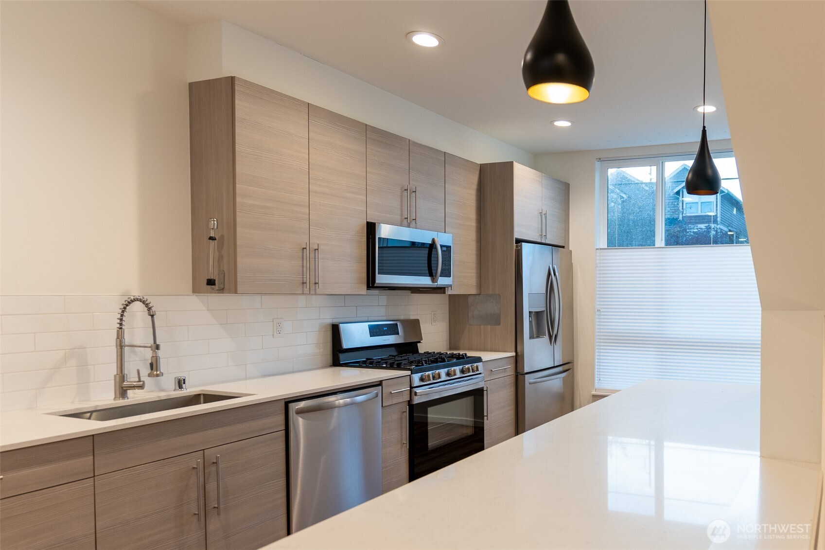9030 18th Avenue Southwest, Unit B Seattle, WA 98106 - Photo 4 of 20 a kitchen with a sink a refrigerator and microwave