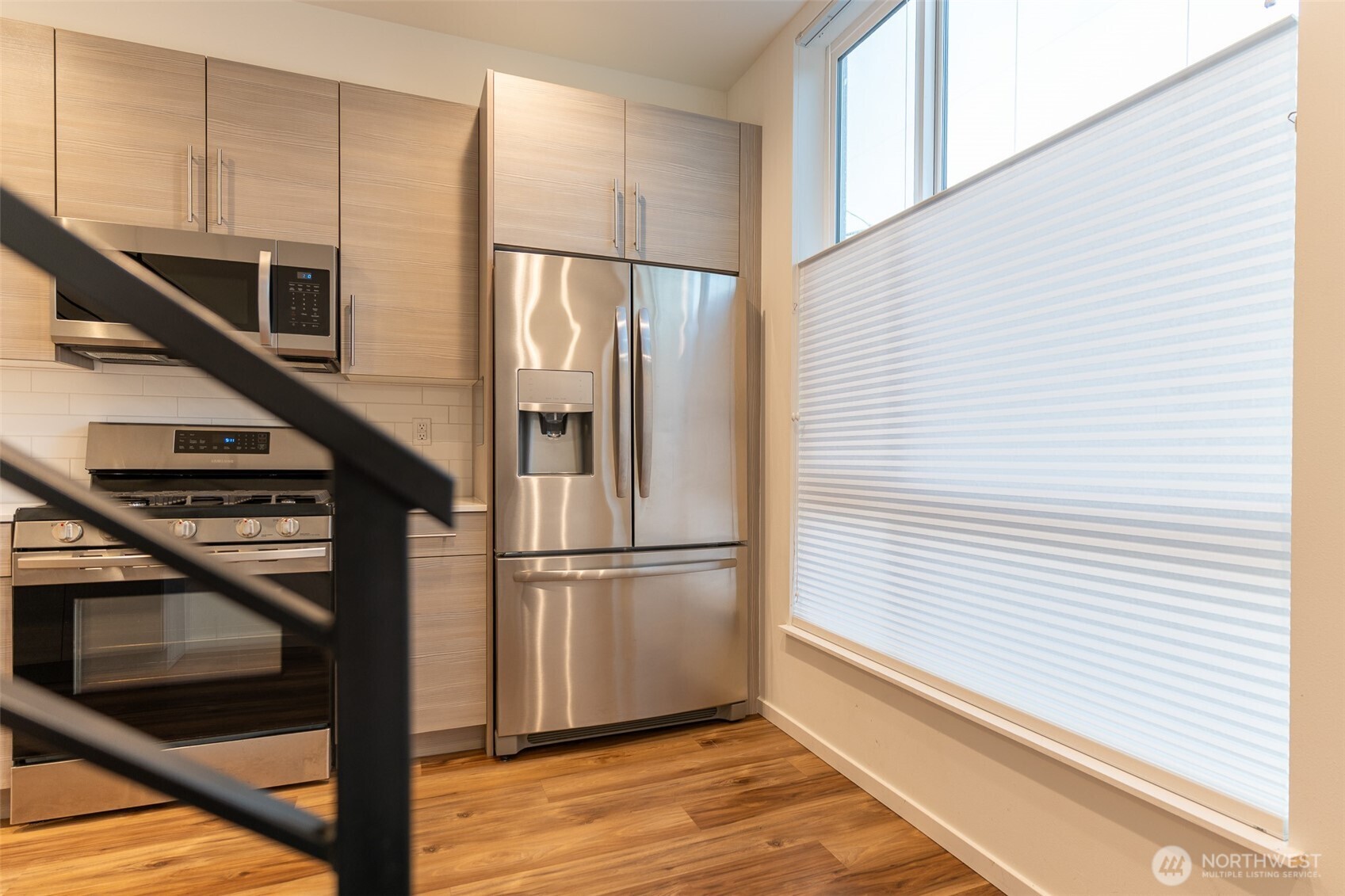 9030 18th Avenue Southwest, Unit B Seattle, WA 98106 - Photo 9 of 20 a kitchen with kitchen island wooden floor and electronic appliances