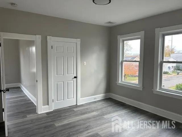 a view of a livingroom with wooden floor and a window
