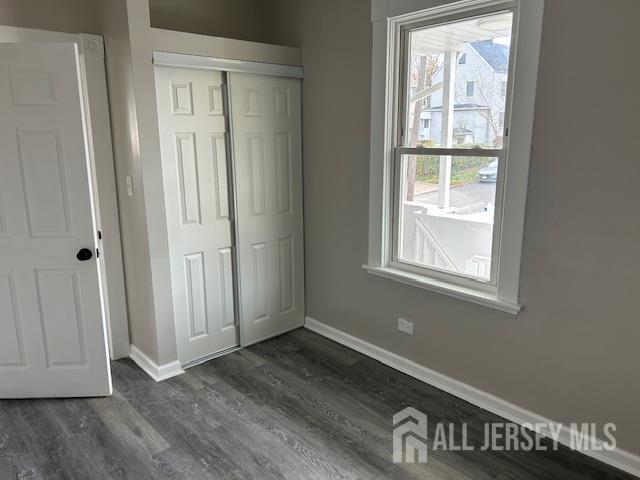 191 Fulton Street, Unit 2 Woodbridge, NJ 07095 - Photo 4 of 22 an empty room with wooden floor closet and windows