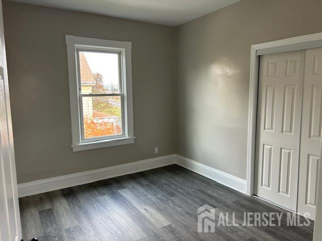 191 Fulton Street, Unit 2 Woodbridge, NJ 07095 - Photo 5 of 22 an empty room with wooden floor and windows