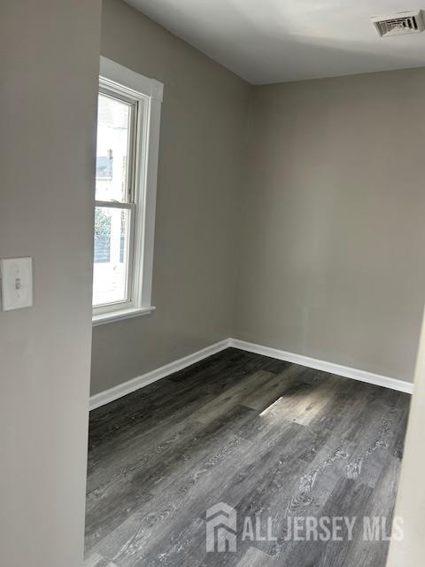 191 Fulton Street, Unit 2 Woodbridge, NJ 07095 - Photo 6 of 22 a view of an empty room with wooden floor and a window