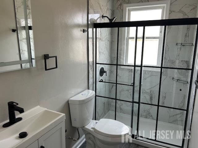 191 Fulton Street, Unit 2 Woodbridge, NJ 07095 - Photo 7 of 22 a white toilet sitting next to a bathroom sink