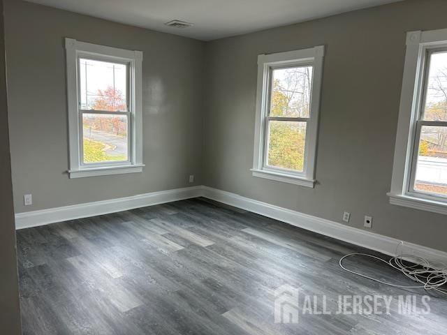 191 Fulton Street, Unit 2 Woodbridge, NJ 07095 - Photo 10 of 22 a view of an empty room with wooden floor and a window
