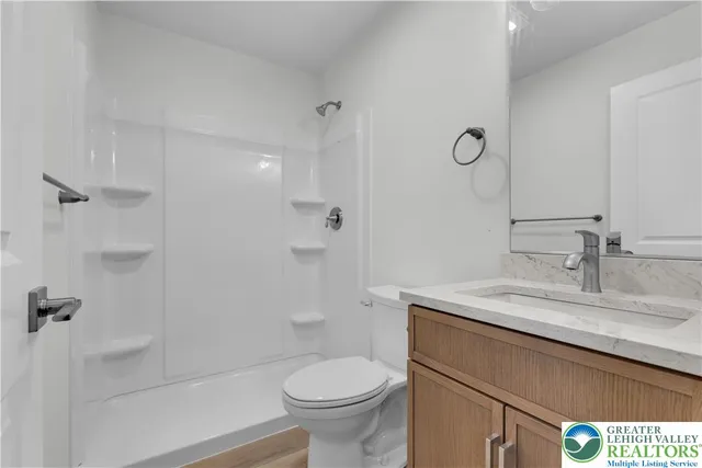 a white toilet sitting next to a bathroom sink