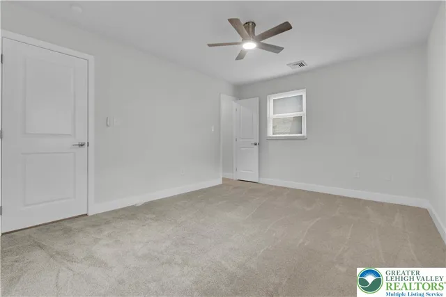 a view of an empty room with a window