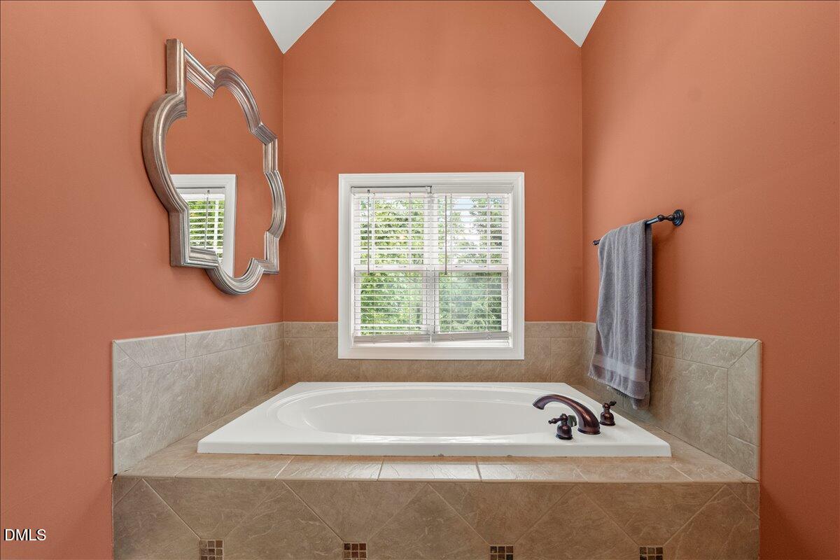 7400 Denlee Road Raleigh, NC 27603 - Photo 20 of 47 a bathroom with a bathtub and a window