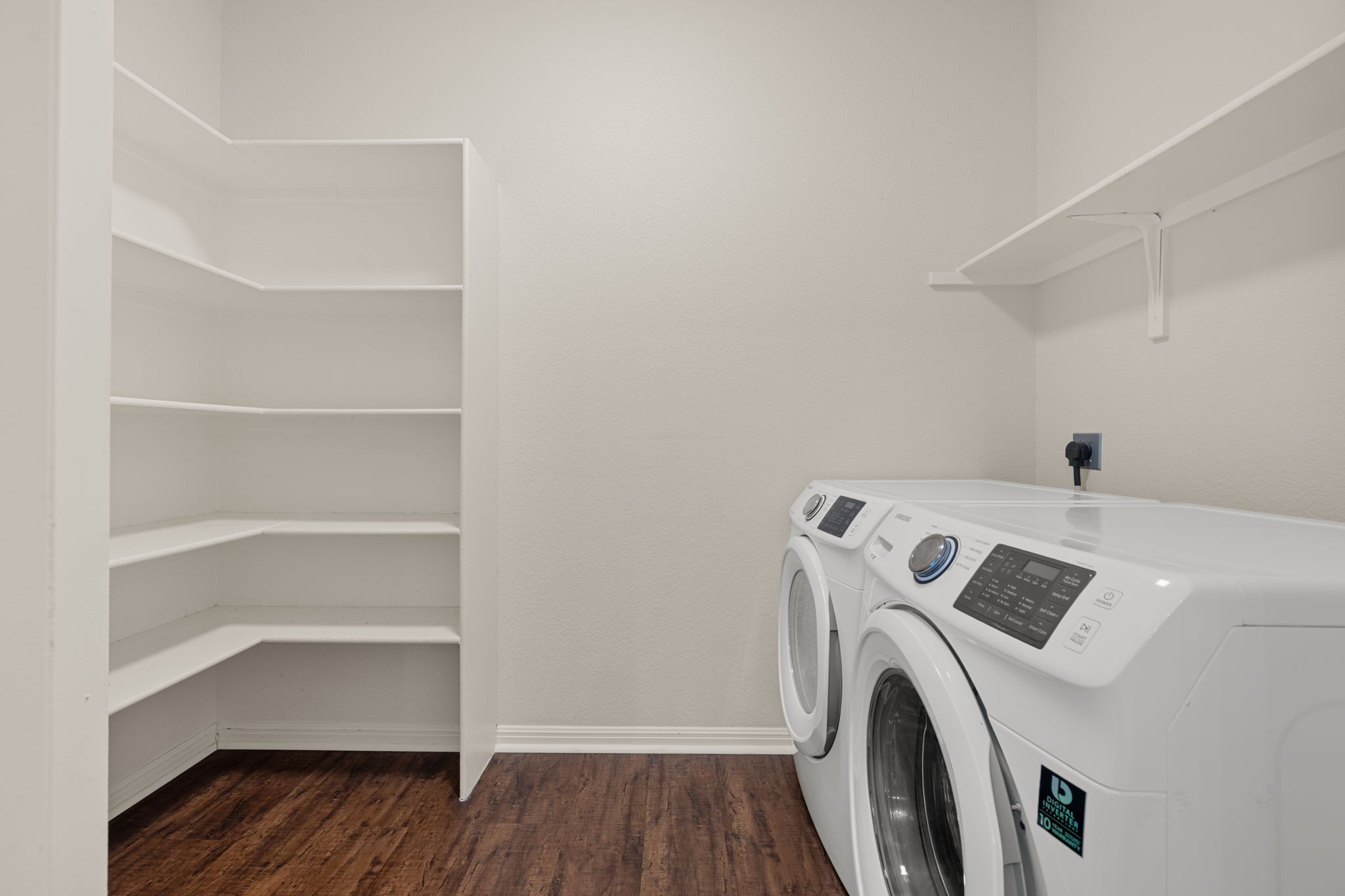 8902 Magna Carta Loop, Unit 122 Austin, TX 78754 - Photo 14 of 39 Ample storage solutions and convenient laundry appliances define this functional utility space.