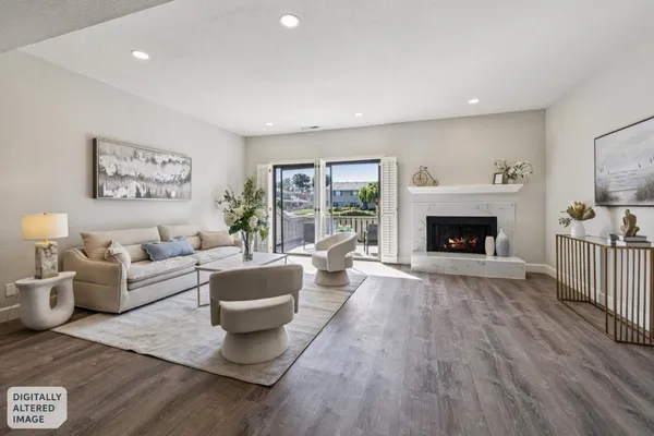 a living room with furniture and a potted plant