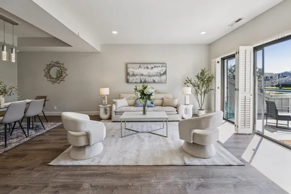 a living room with furniture and a floor to ceiling window