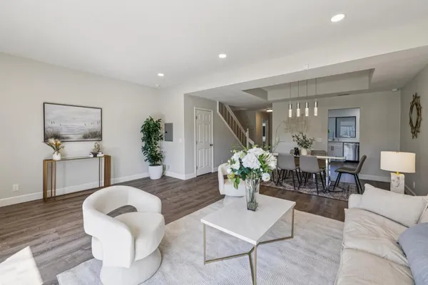 a balcony with wooden floor and outdoor seating