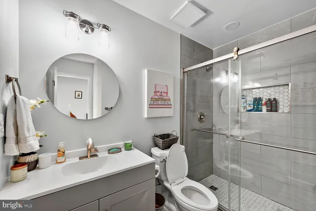 a bathroom with a toilet sink and shower