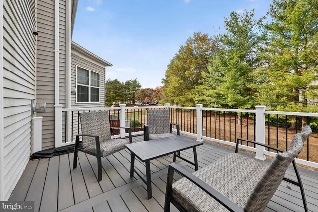 a view of a roof deck with wooden floor and furniture