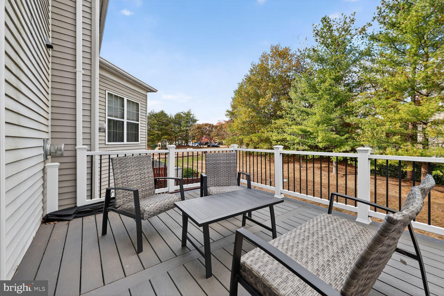 13486 Grouserun Lane Bristow, VA 20136 - Photo 15 of 20 a view of a roof deck with wooden floor and furniture