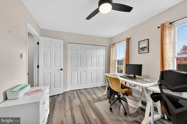 a view of a workspace with furniture and a window