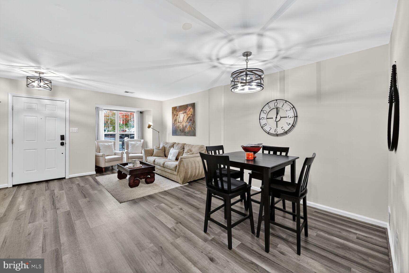 13486 Grouserun Lane Bristow, VA 20136 - Photo 2 of 20 a view of a dining room and livingroom with furniture wooden floor and a clock