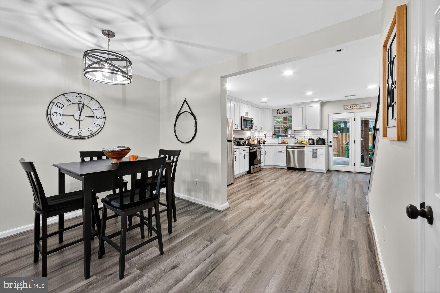 13486 Grouserun Lane Bristow, VA 20136 - Photo 4 of 20 a view of a dining room with furniture window and wooden floor