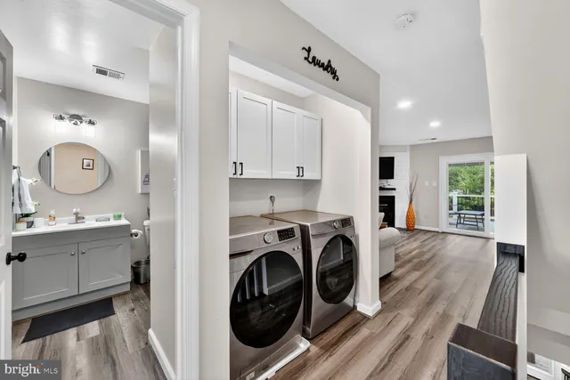 a view of a kitchen with sink washer and dryer