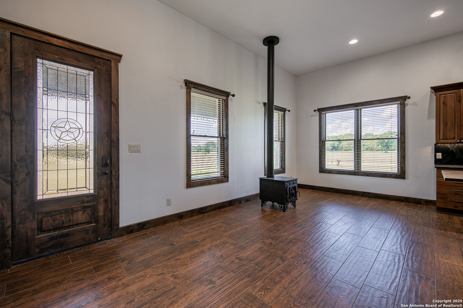 9560 Old Colony Line Road Dale, TX 78616 - Photo 11 of 41 an empty room with wooden floor and windows