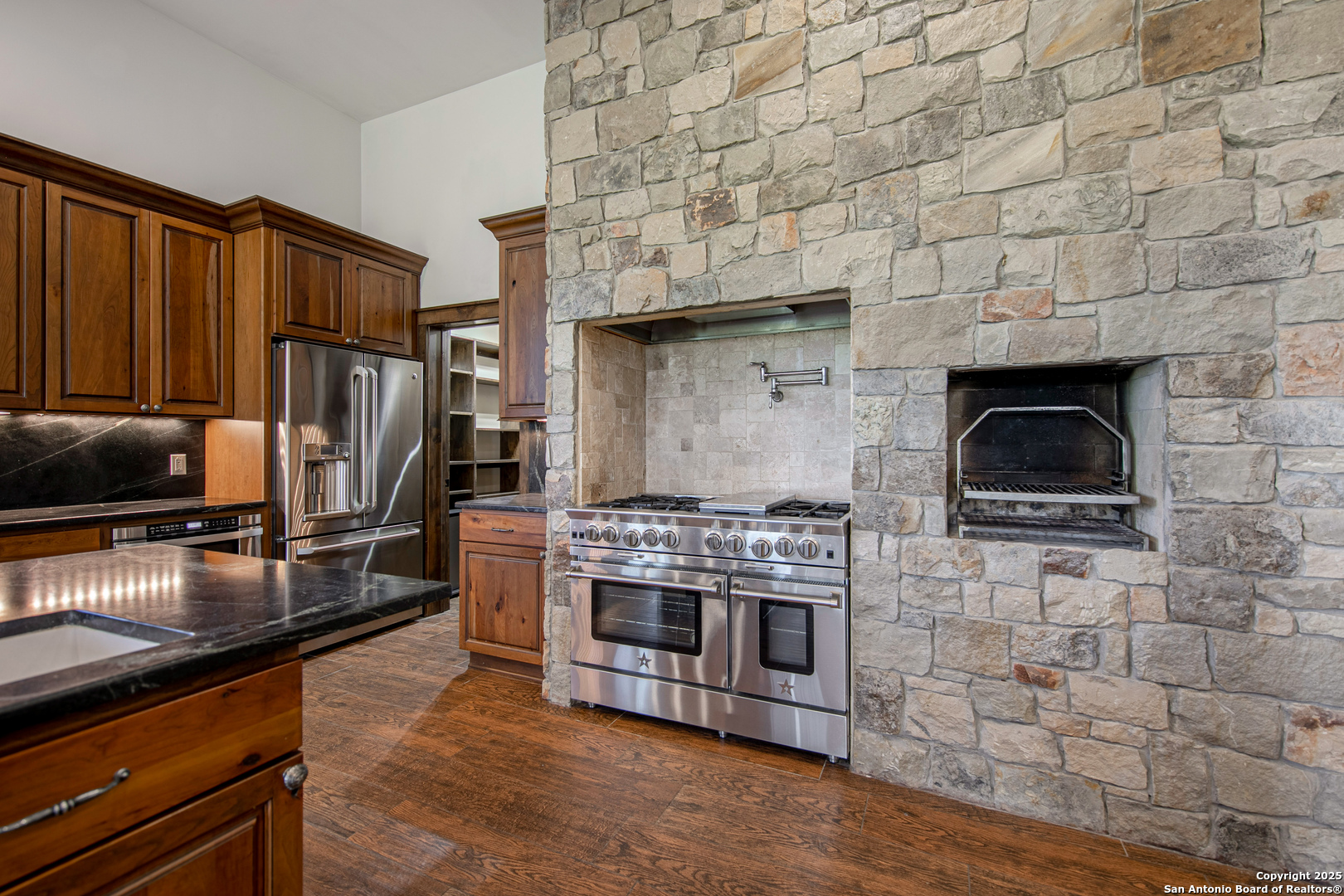 9560 Old Colony Line Road Dale, TX 78616 - Photo 12 of 41 a kitchen with stainless steel appliances wooden cabinets a stove and a refrigerator